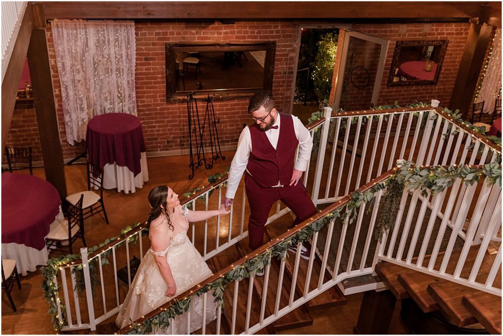 photo of bride and groom on small wooden staircase