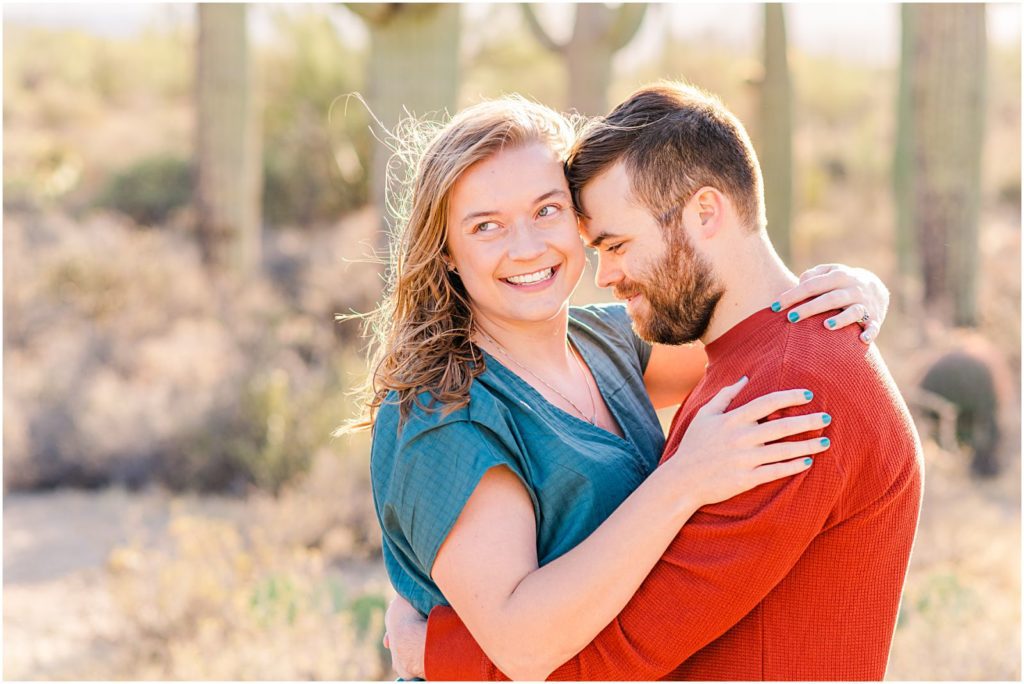 guy nuzzling in while girl smiles