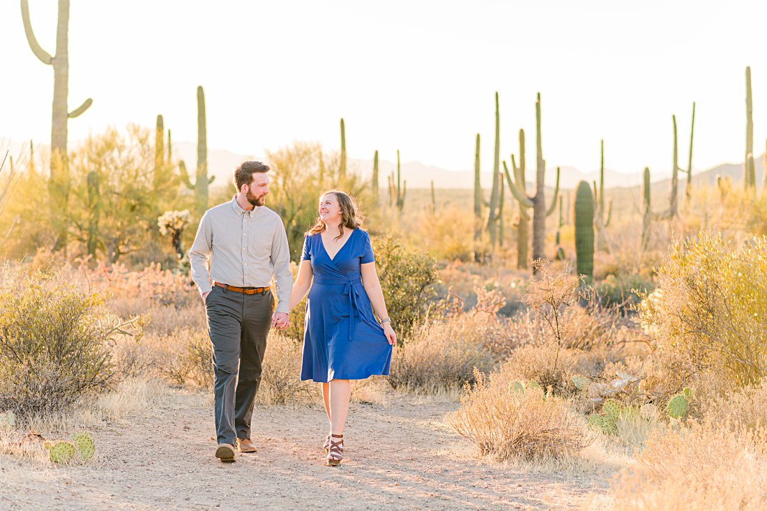 vibrant fall engagement session in the desert with couple holding hands and walking