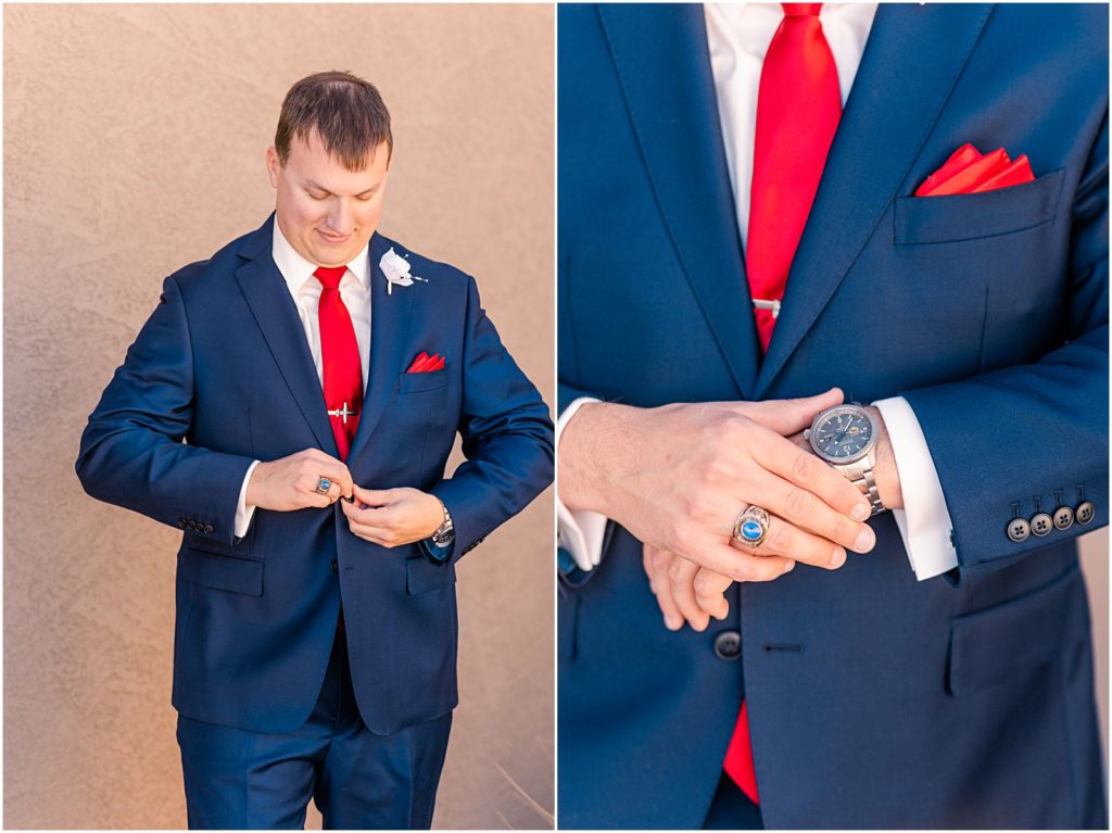 groom in navy suit getting ready buttoning his jacket