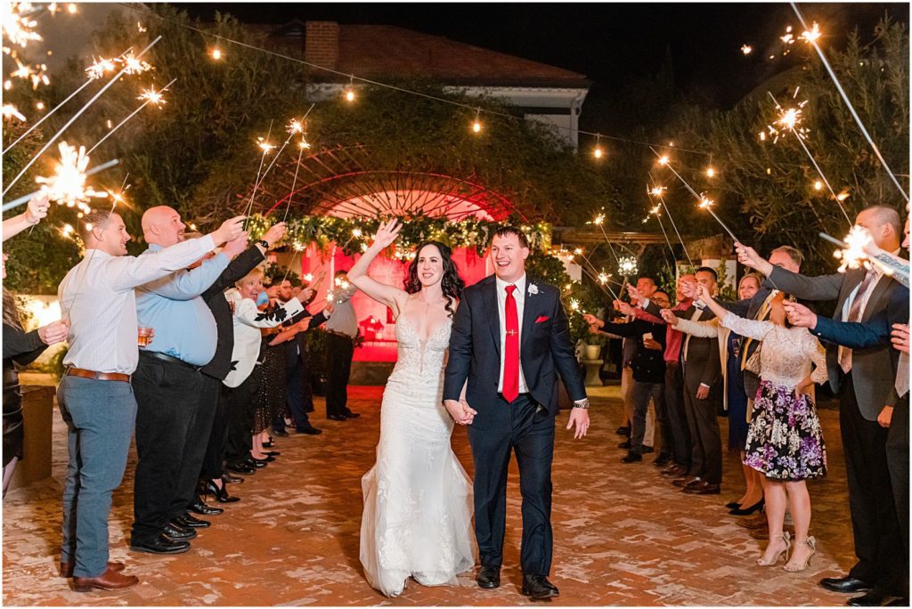 nighttime sparkler exit in courtyard at vow renewal in Tucson
