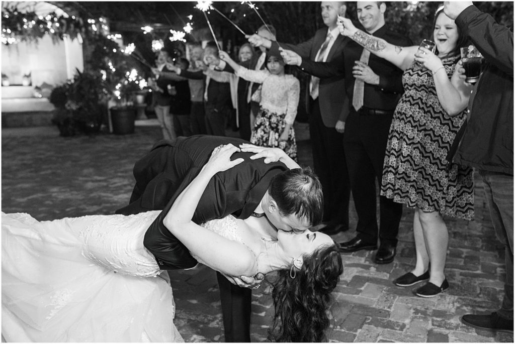 husband dramatically dips wife and kisses her during sparkler reception exit
