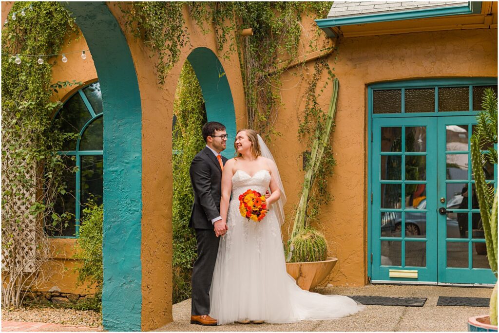 couple standing in colorful archway