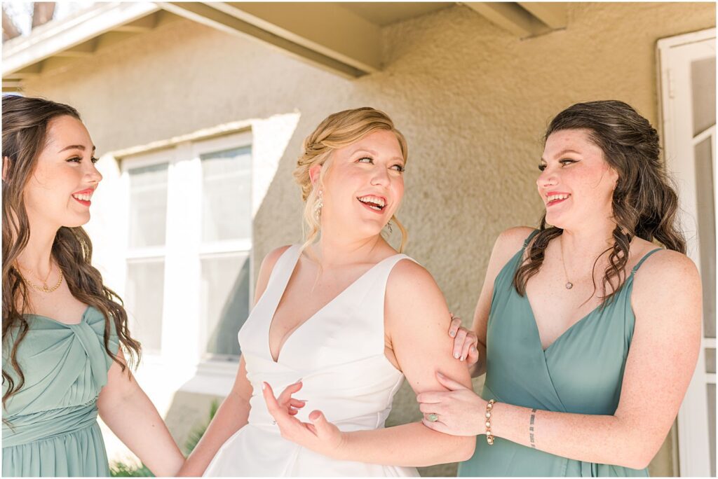 bridesmaids with bride in morning as she gets ready