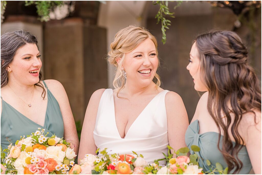bride smiling at her bridesmaids