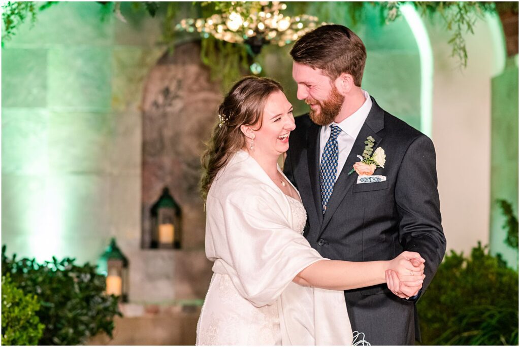 bride and groom sharing first dance together at reception