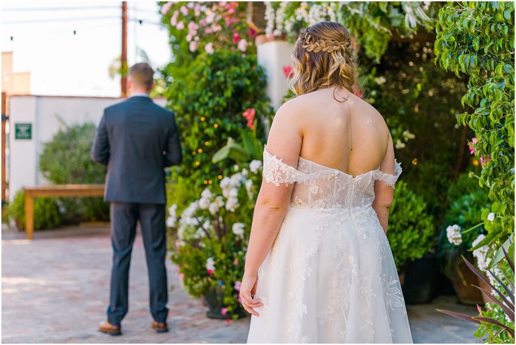 bride walking up behind groom