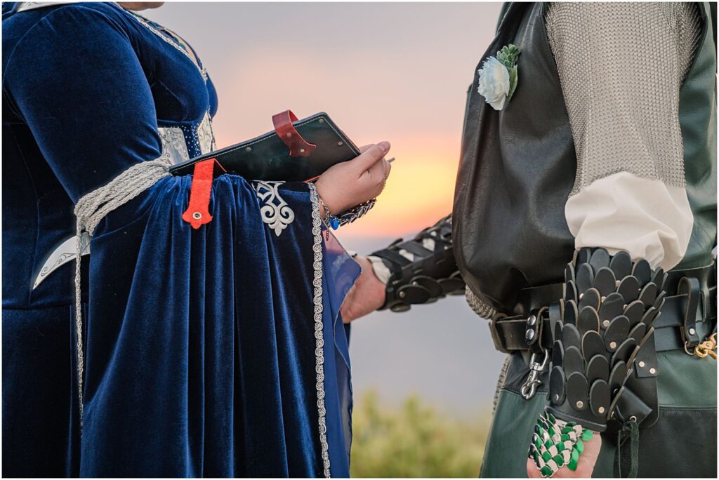 bride and groom exchange private vows during sunset at fantasy themed wedding