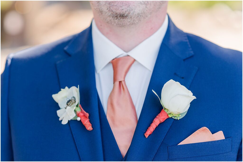 groom wearing two boutonnieres