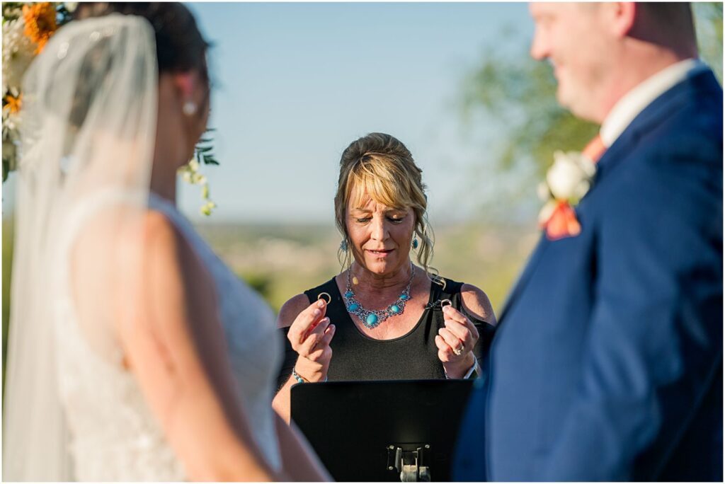 officiant holding up wedding rings