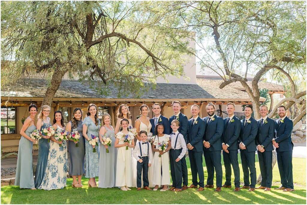 wedding party wearing shades of blue with two flower girls and two ring bearers