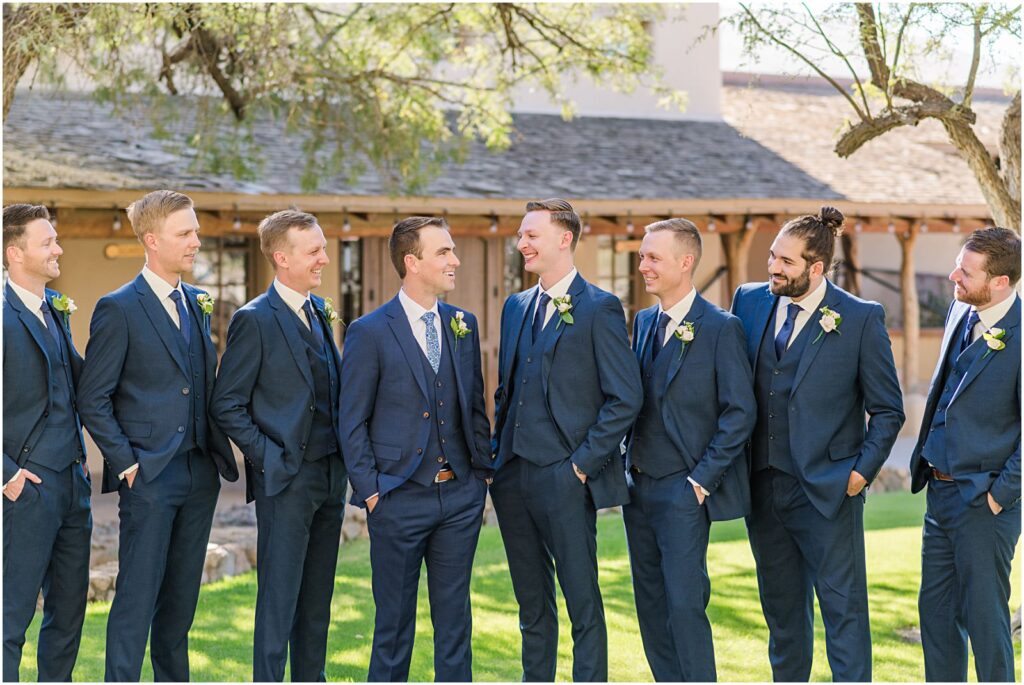 groom laughing with his best man and groomsmen