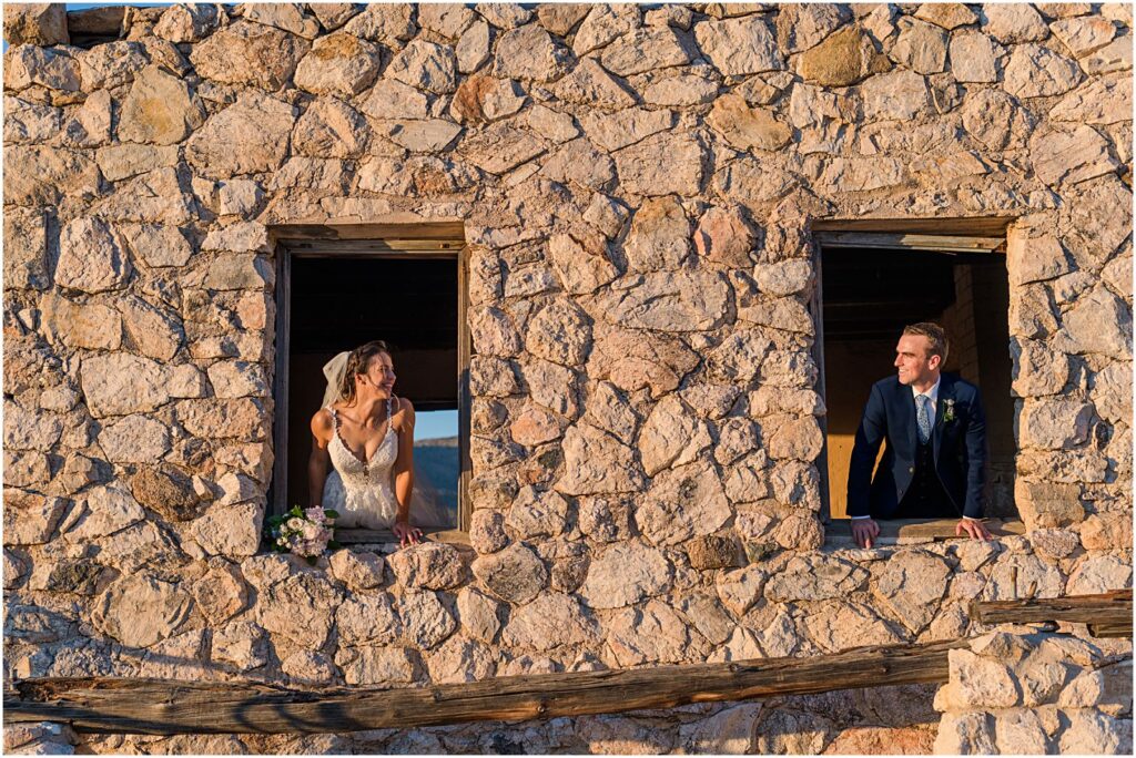 couple leaning out of old windows looking at each other