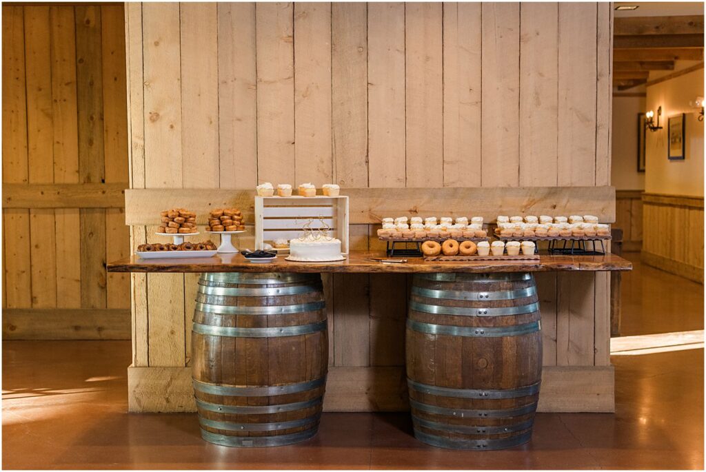 rustic cake table with desserts on barrels